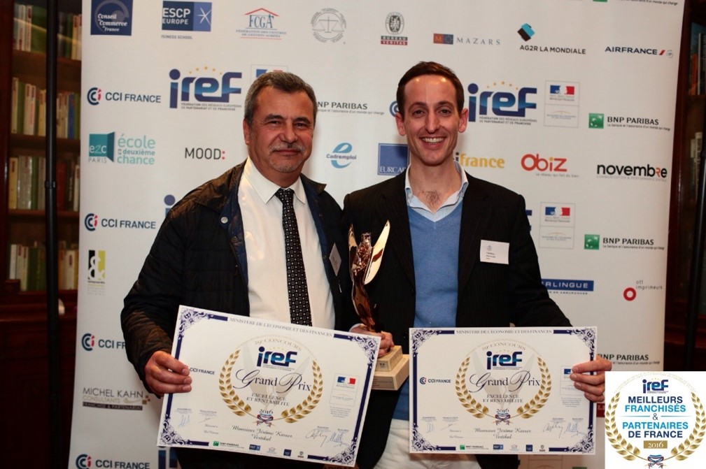 Deux hommes tenant des trophées et des diplômes VERTIKAL.