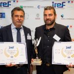 Homme avec trophée et certificat VERTIKAL lors d'un événement IREF.